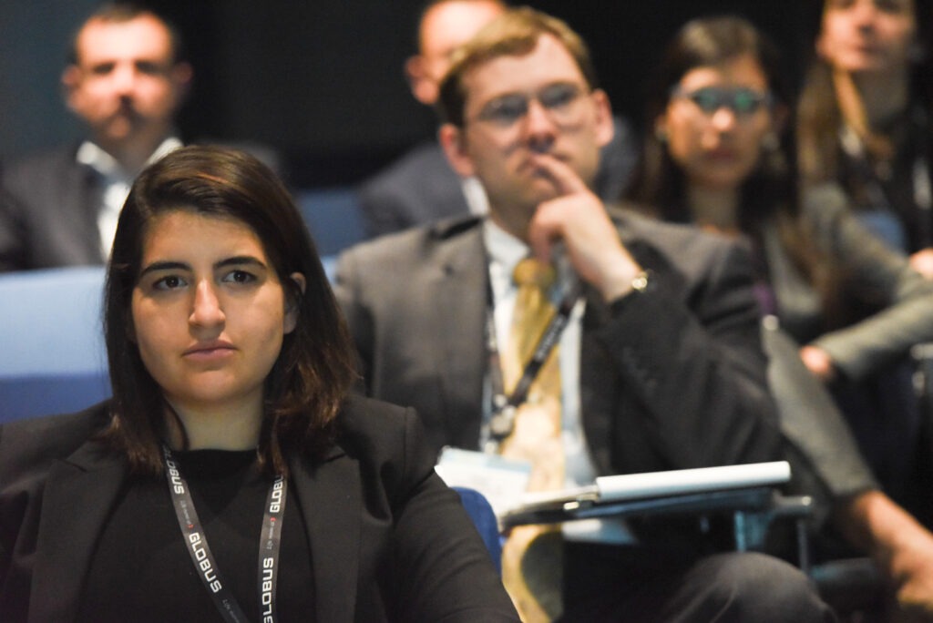 People sitting down focused in a meeting