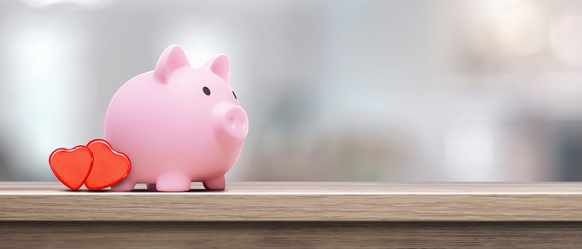 pink piggy bank with hearts - concept of protection and preservation of love - copy space