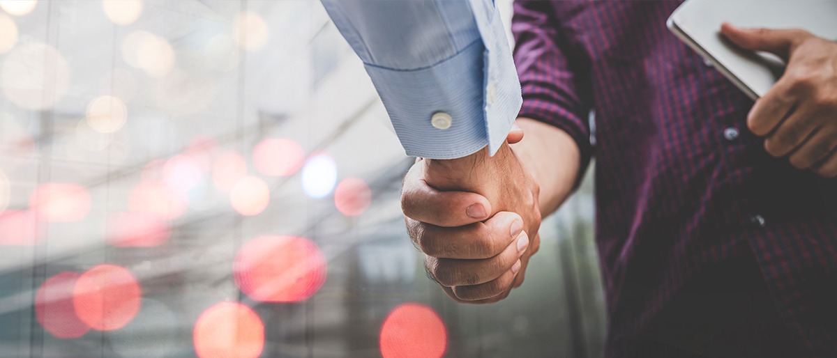 Two businessman shaking hands with business deals and congratulations on success, panorama image use for cover design.